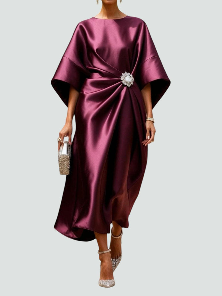 Women's formal kimono sleeve satin midi dress in a rich color, featuring a unique brooch detail.