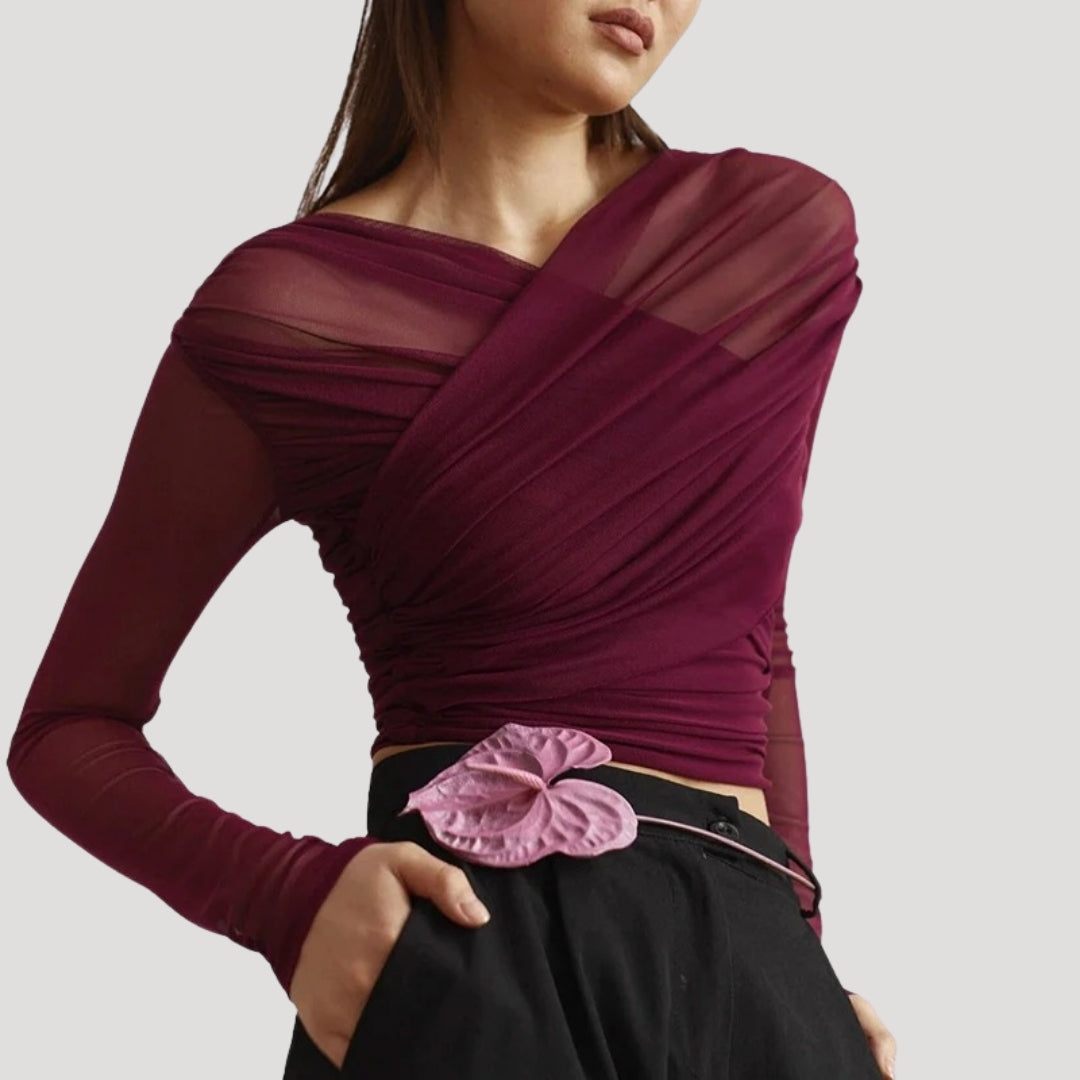 Close-up of a women's sheer wrap long-sleeve top, highlighting the delicate fabric.