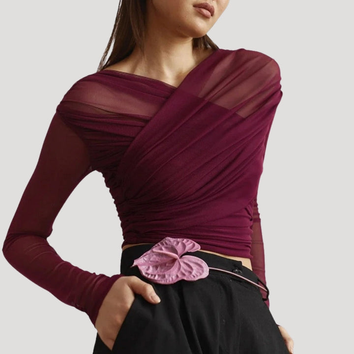 Close-up of a women's sheer wrap long-sleeve top, highlighting the delicate fabric.