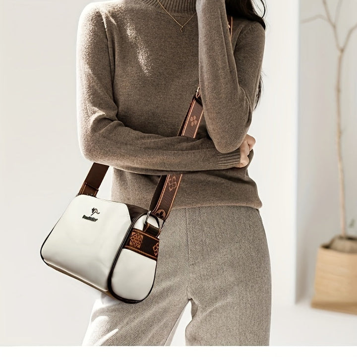 Stylish women's shoulder bag with adjustable strap for daily use. Elegant design, ideal work accessory.