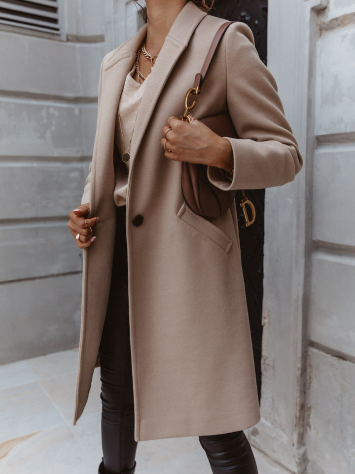 Front view of a women's elegant formal coat with a single row of buttons, suitable for various occasions.
