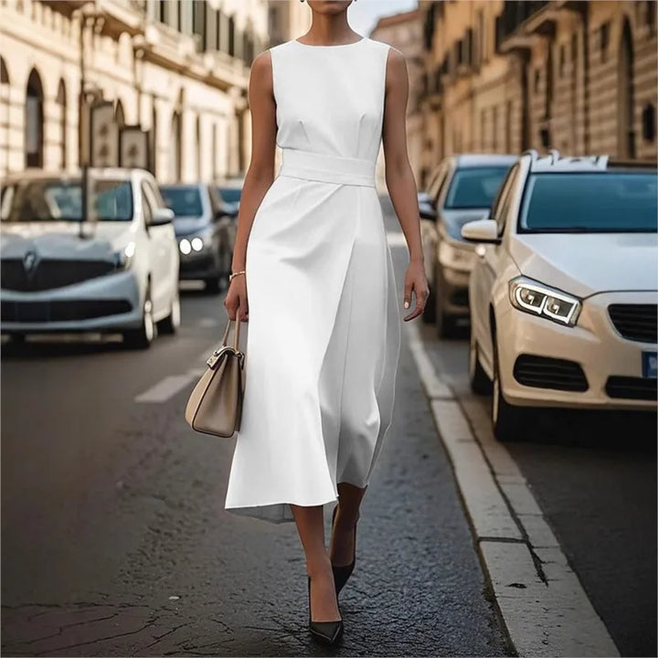Women's sophisticated black sleeveless midi dress with a round neckline and elegant pleated waist detail.