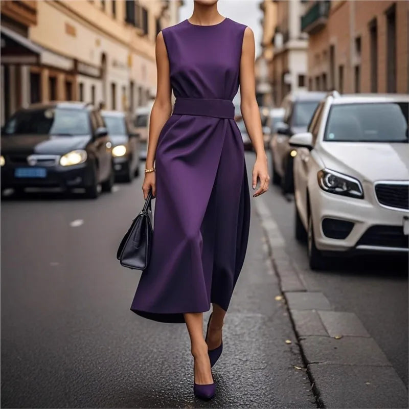 Close-up of the elegant round neck and pleated waist of a women's flowy midi summer dress.