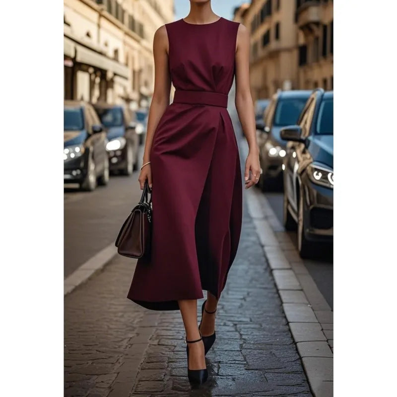 Woman posing in a beautiful blue round neck midi dress, highlighting its pleated waist and elegant style.