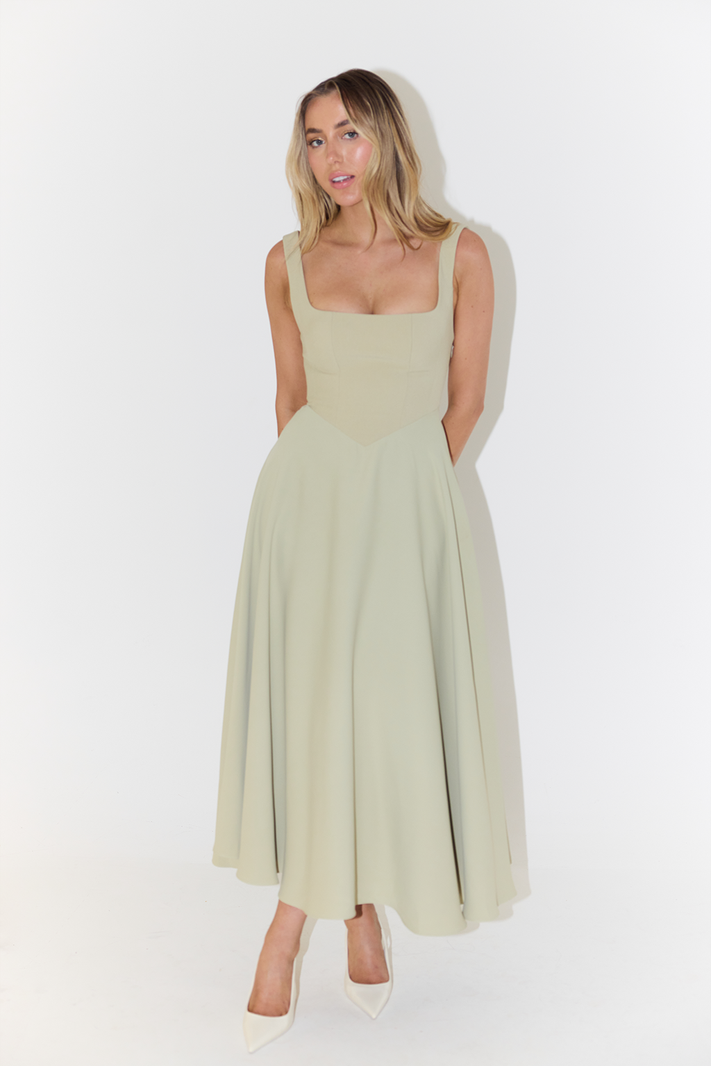 Detailed square neck on women's elegant sleeveless midi dress. A stylish feature for summer's versatile look.