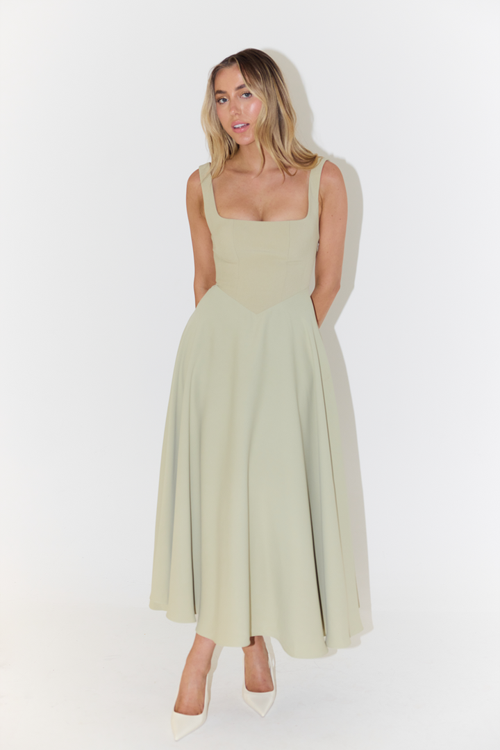 Detailed square neck on women's elegant sleeveless midi dress. A stylish feature for summer's versatile look.