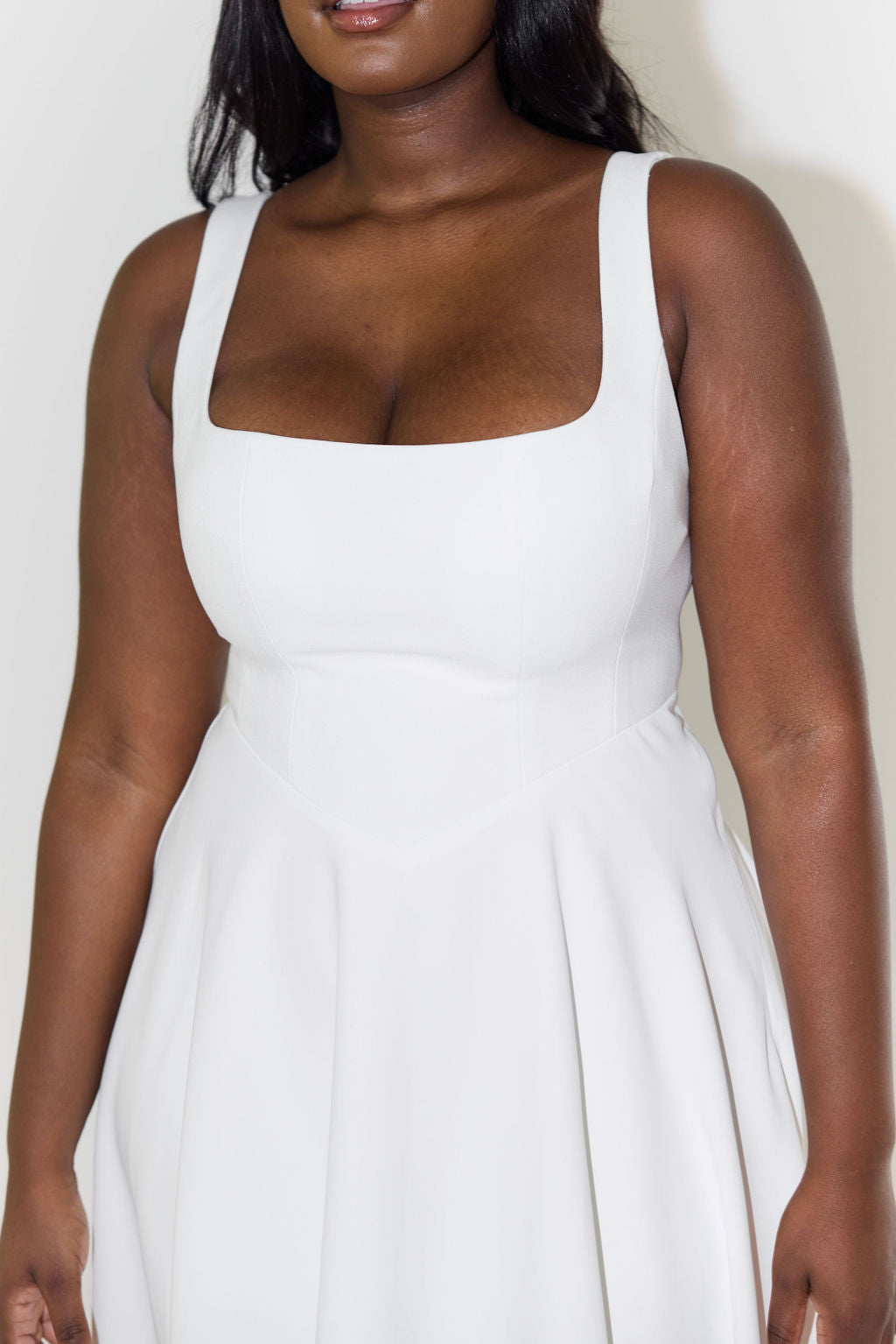 Woman modeling elegant square neck sleeveless midi dress, showcasing its versatile summer style.