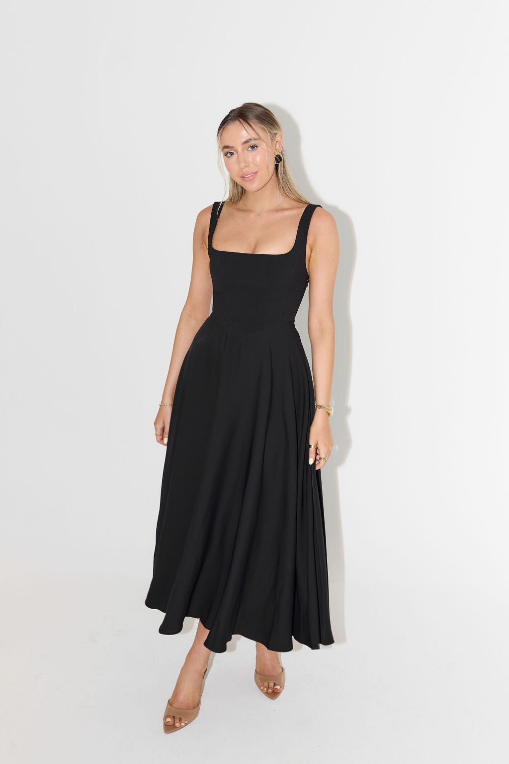 Sophisticated women's square neck sleeveless midi dress. Elegant casual or evening wear for summer fashion.
