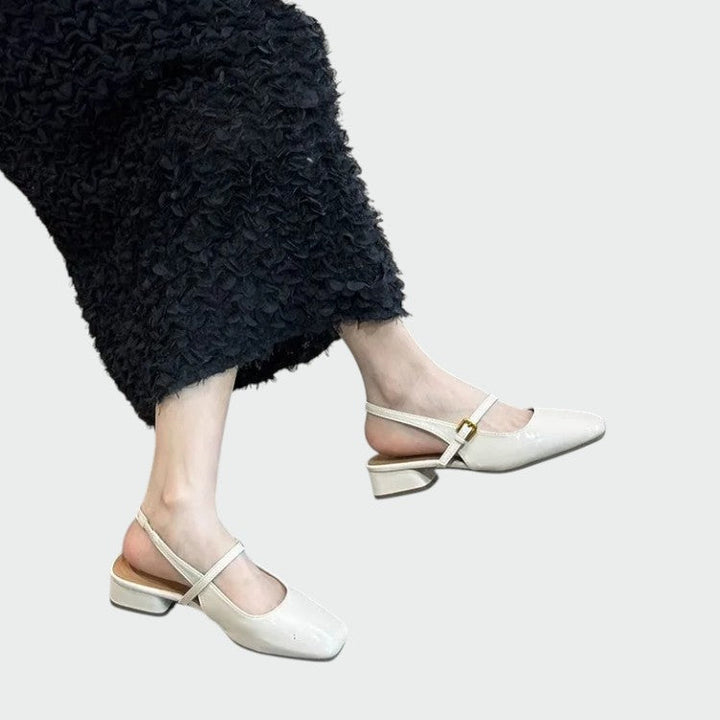 Classic women's Mary Jane block heels with a modern square toe and adjustable strap for comfort.