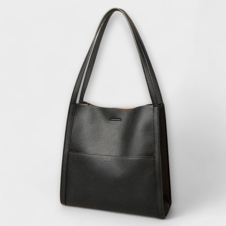 Modern women's structured handbag, featuring a sleek design, suitable as an everyday or elegant shoulder bag.