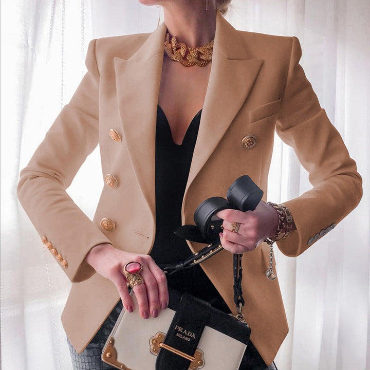Stylish women's blazer in a tailored fit, adorned with shiny gold buttons, enhancing its appeal for business and evening.