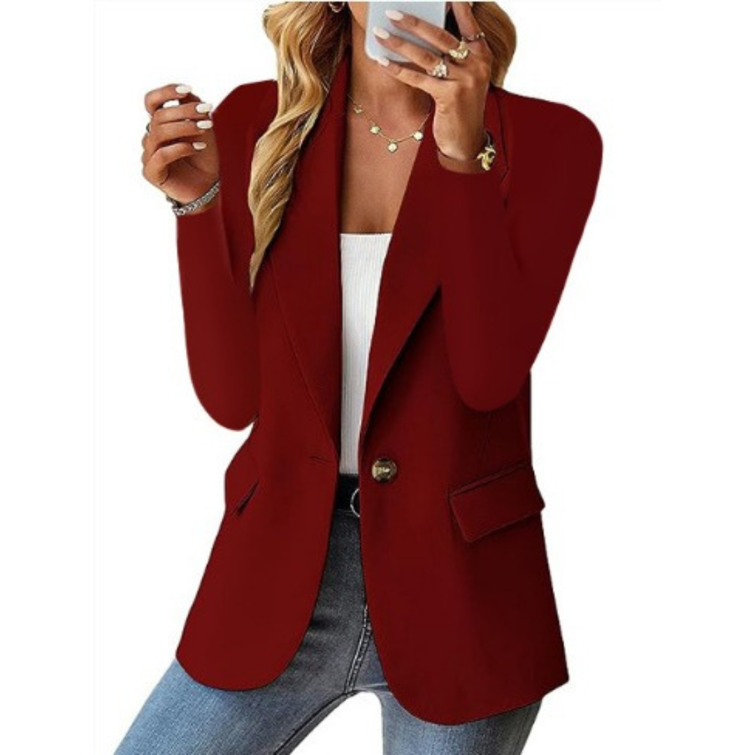 Detail of the lapel and single-button closure on an elegant women's tailored blazer jacket.