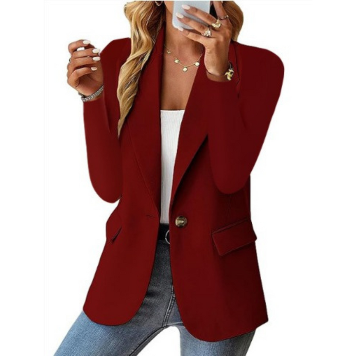 Detail of the lapel and single-button closure on an elegant women's tailored blazer jacket.