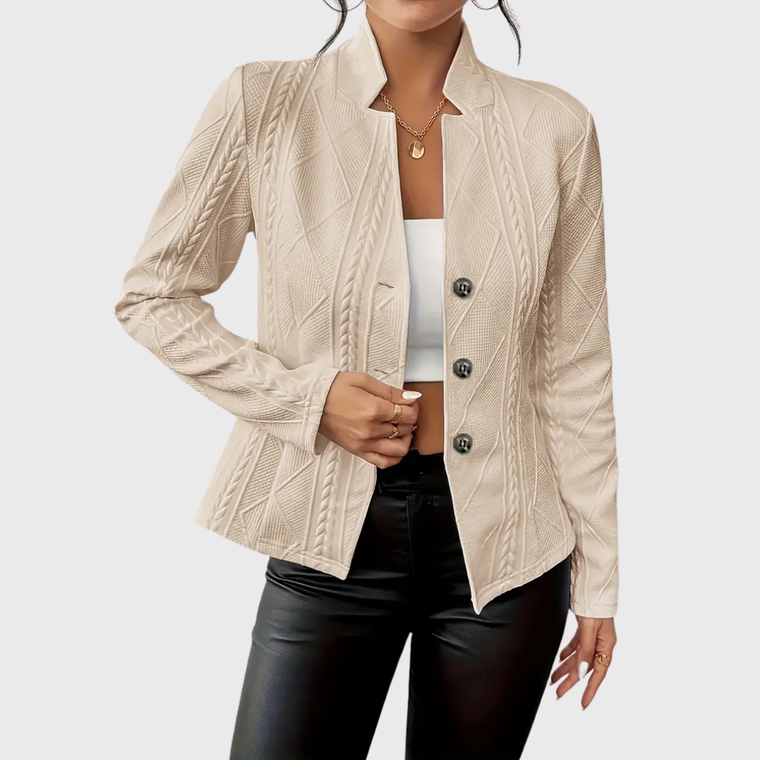 Modern women's tailored blazer in a neutral color, showcasing its elegant cut and fashion-forward style.