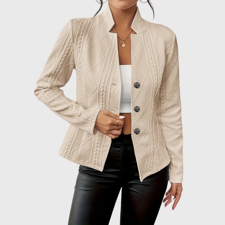 Modern women's tailored blazer in a neutral color, showcasing its elegant cut and fashion-forward style.