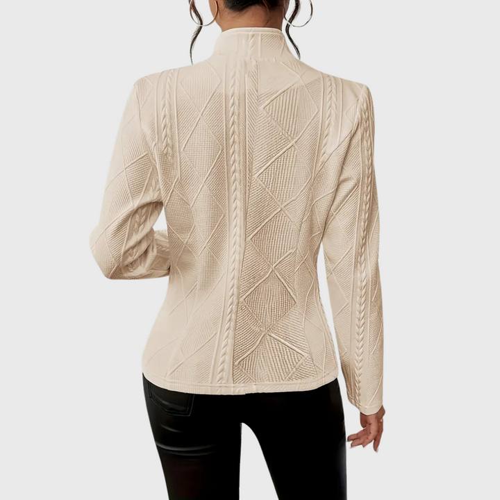 Close-up of a women's tailored blazer fabric, highlighting the quality, elegant details, and versatile design.