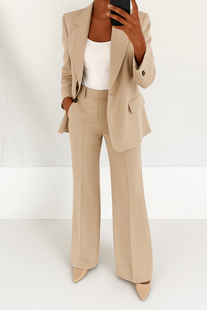 Stylish women's elegant two-piece suit. Features a tailored blazer and classic trousers for formal wear.