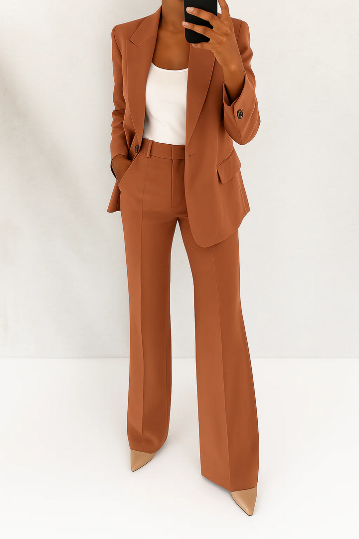 Business attire: a sophisticated women's two-piece suit with blazer & trousers, ideal for professional settings.