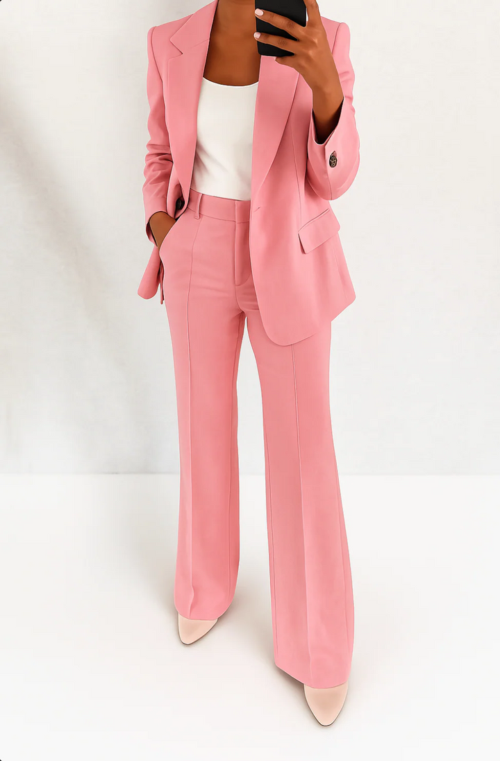 Tailored women's two-piece suit featuring an elegant blazer and slim-fit trousers. Modern office fashion.