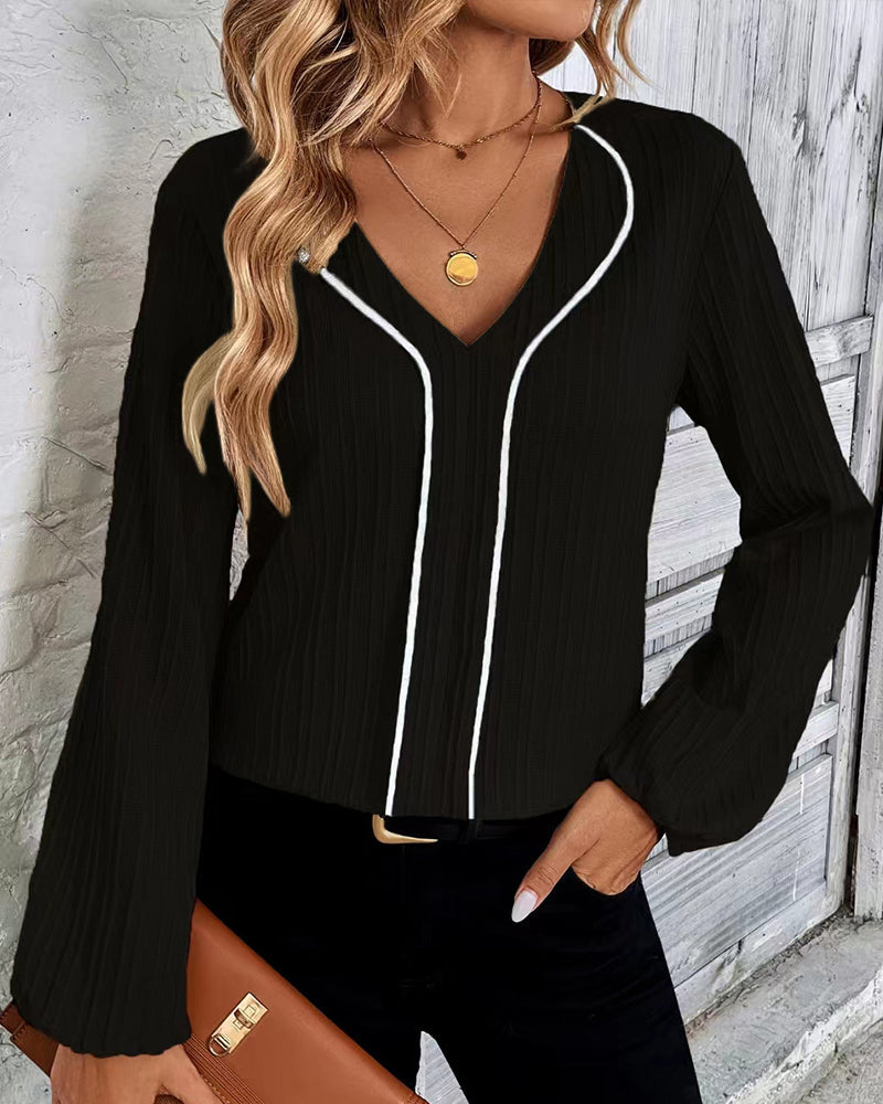 Chic women's V-neck top with voluminous balloon sleeves, an elegant choice for work or sophisticated casual.