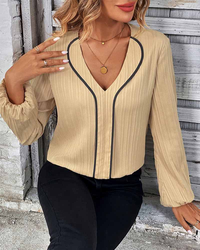 Modern women's long sleeve top, V-neck design with stylish balloon sleeves, ideal for day-to-night fashion.