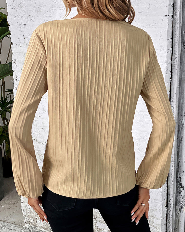 Comfortable women's V-neck top, long balloon sleeves, offering an elegant yet casual fashion statement.