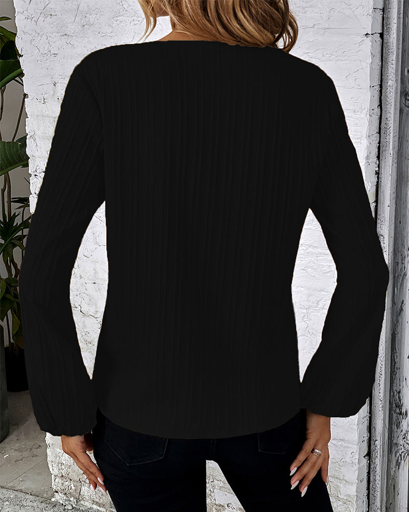 Women's solid V-neck long sleeve top featuring elegant balloon sleeves, a versatile and chic wardrobe staple.