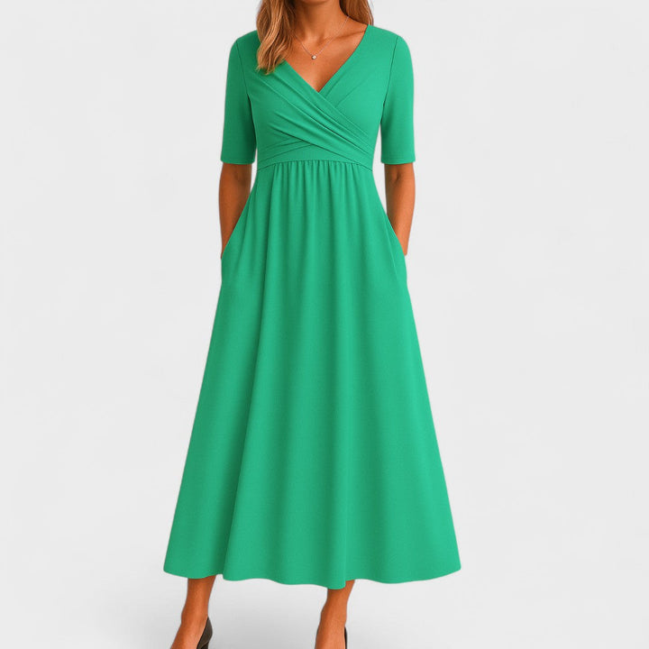 Fashionable women's midi dress with V-neck, pleated details, and practical pockets for daily wear