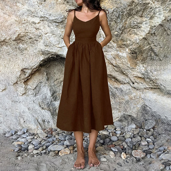 Flowy sleeveless midi dress for women, offering a sophisticated V-neck and daring open back