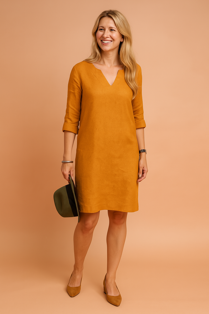Comfortable women's shift dress with V-neck and 3/4 sleeves. Versatile for casual or office wear.
