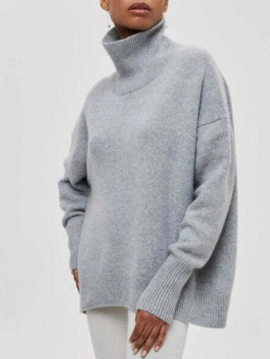 Woman models an elegant warm turtleneck sweater, showcasing its chic style and comfortable long-sleeve fit.