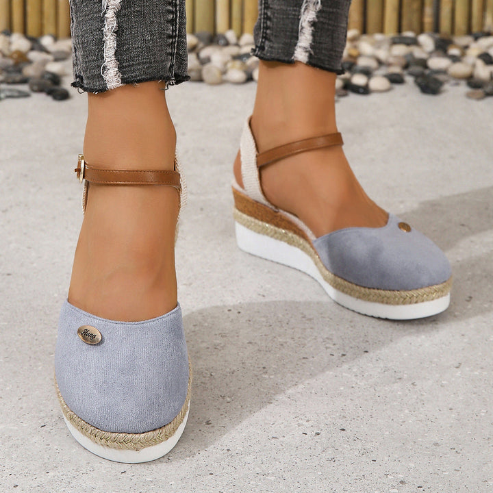 Elegant women's slip-on wedge sandals with woven straps, designed for comfortable summer fashion.