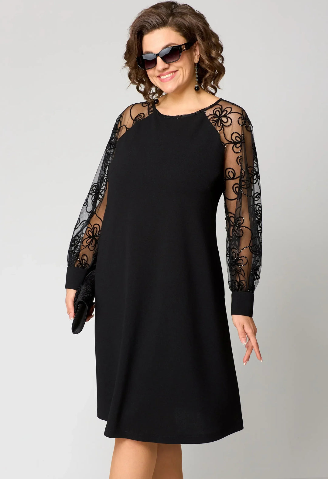 Close-up of intricate floral embroidery on an elegant white lace A-line dress