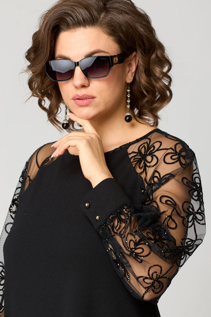 Woman posing in a beautiful white long-sleeve lace A-line evening dress
