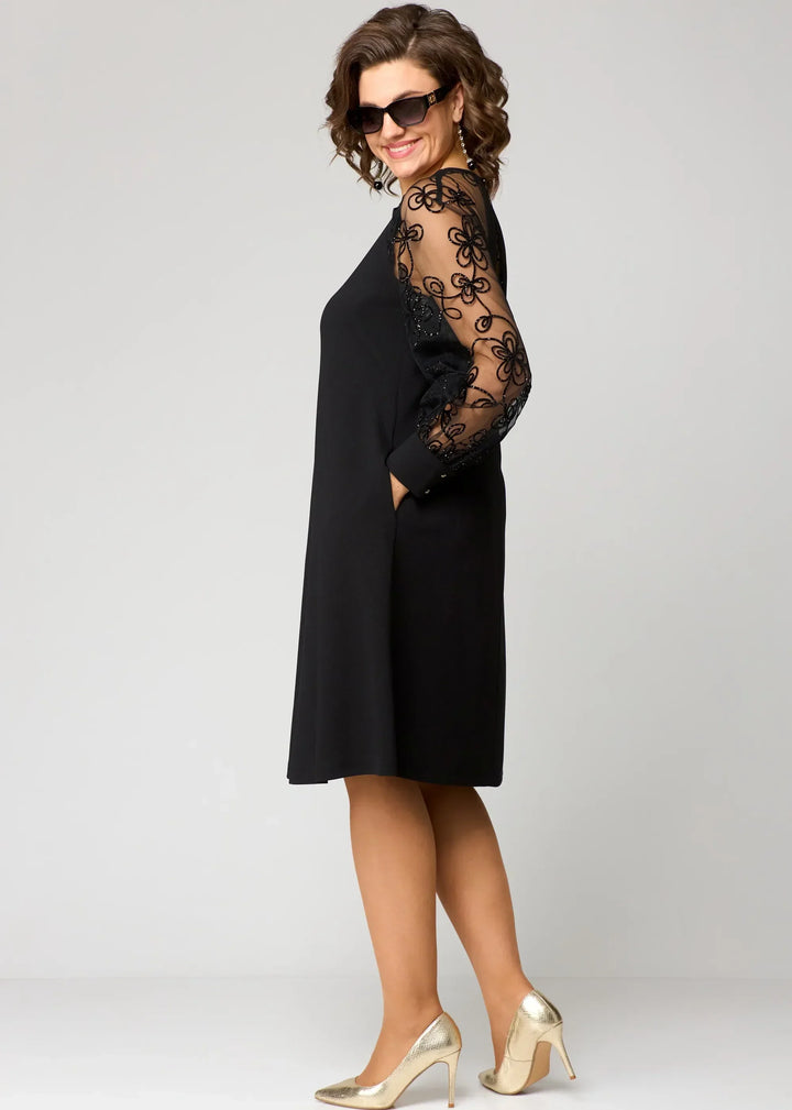 Detailed shot of delicate lace fabric on a women's elegant A-line party dress