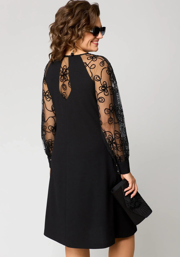Stylish woman in a white long sleeve embroidered lace A-line dress, front view