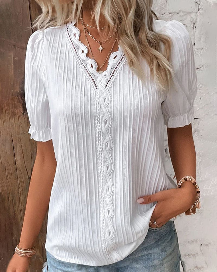 Casual chic women's V-neck top with intricate floral lace detailing.
