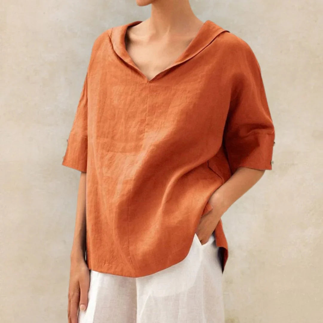 Woman wearing a relaxed fit white linen button-down shirt outdoors, perfect for summer