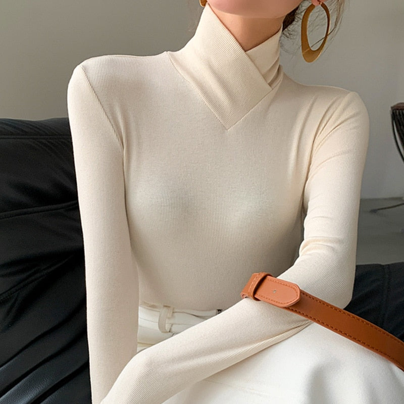 Elegant women's white mock neck long sleeve top, perfect for spring fashion and versatile workwear.