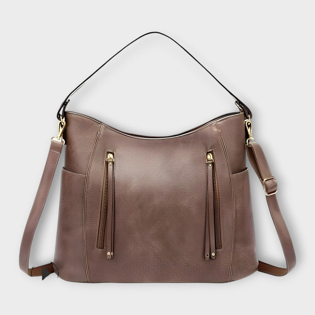 Chic women's pink shoulder bag, a fashionable everyday bag for spring, featuring a sleek design and ample storage.