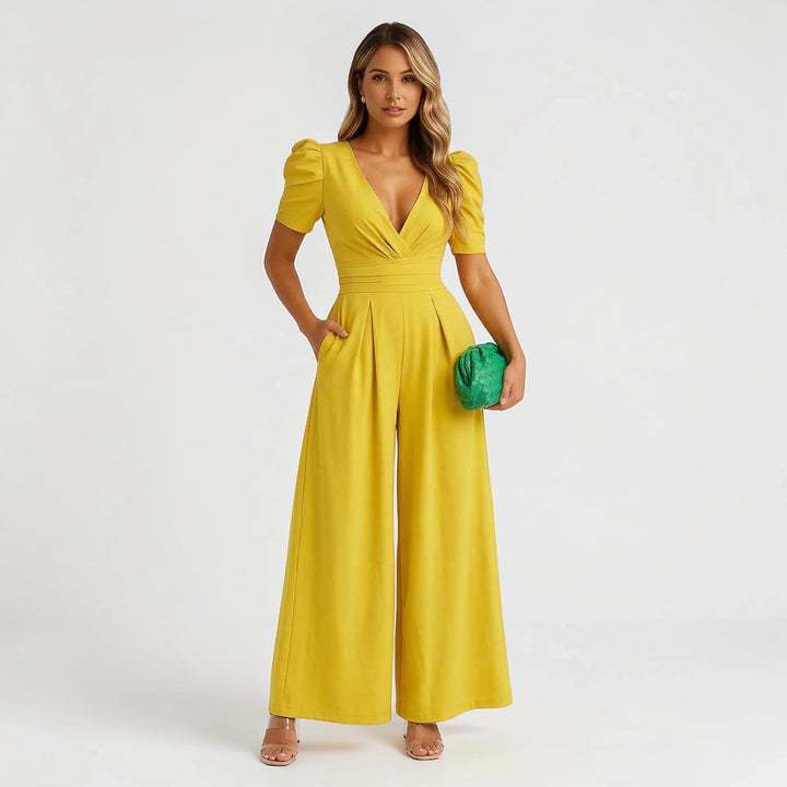 Green tailored wide leg jumpsuit with puff sleeves, an elegant choice for any occasion.