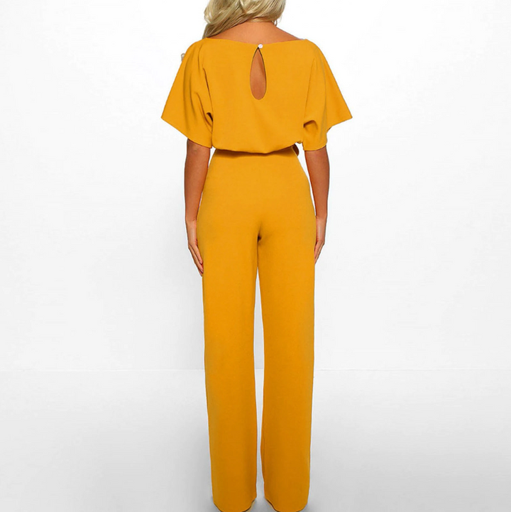 Formal women's wide leg jumpsuit. Features elegant flutter sleeves, perfect for business or special occasion wear.