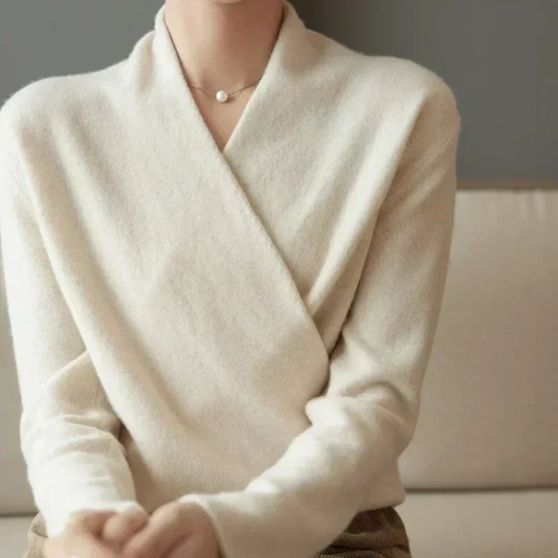 Stylish women's wrap neck knit top in black, a comfortable long sleeve for elegant everyday wear.