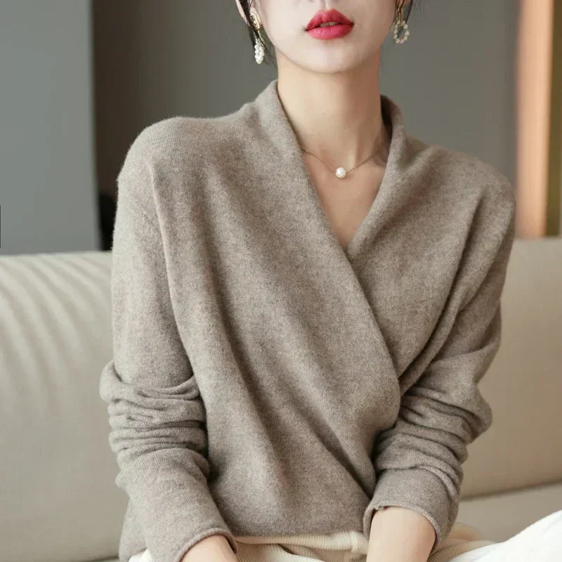 Details of the elegant wrap neck design on a women's knit top, emphasizing its unique appeal.