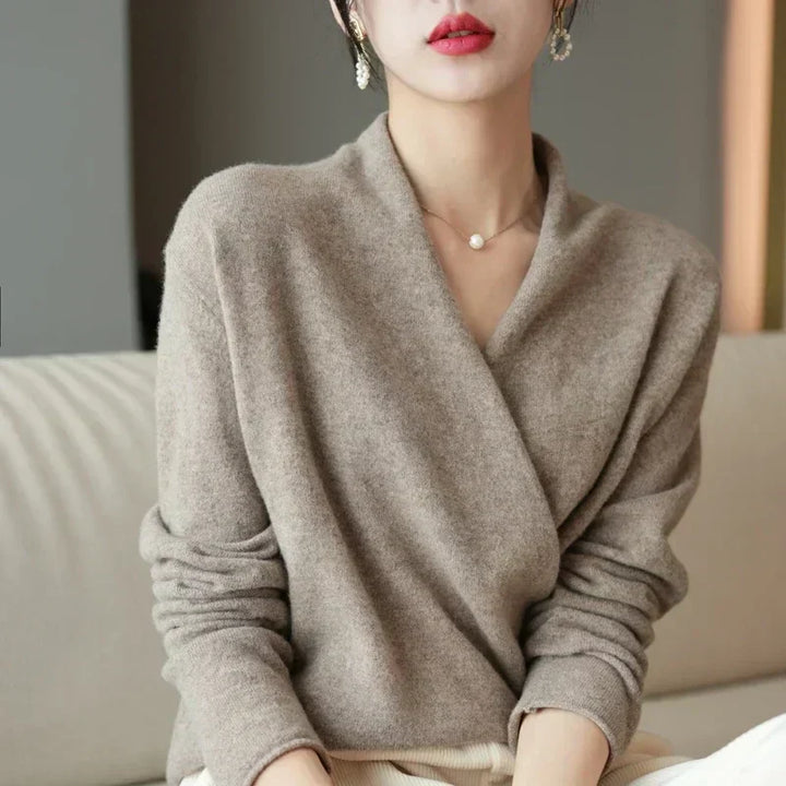 Details of the elegant wrap neck design on a women's knit top, emphasizing its unique appeal.