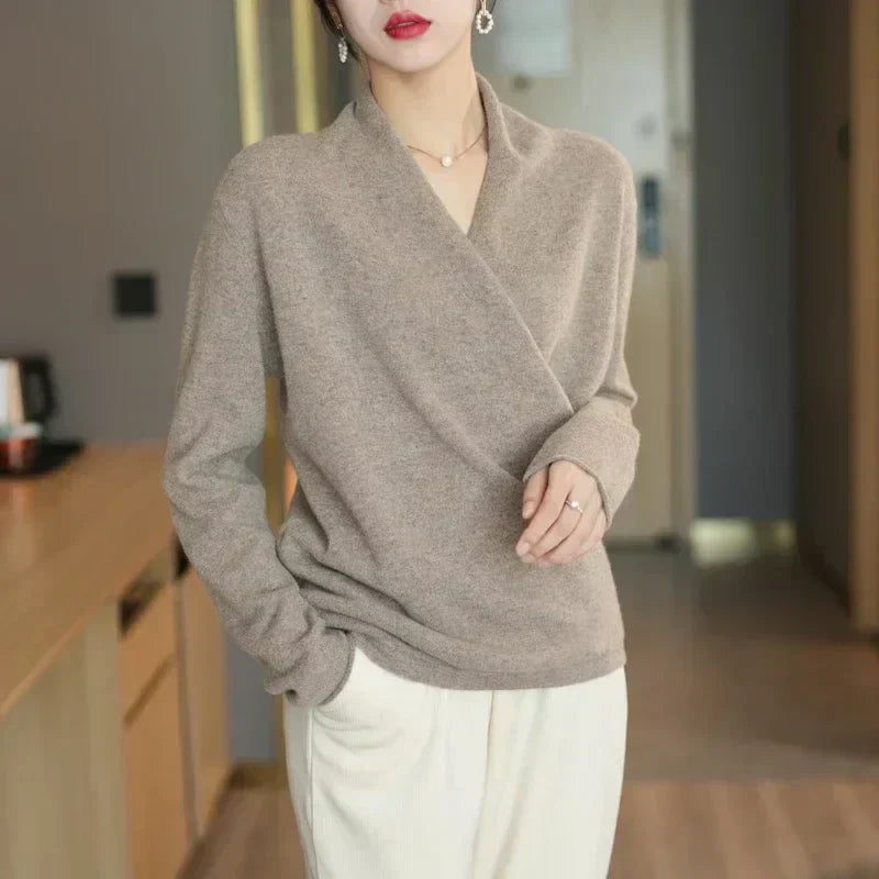 Full-length shot of a women's wrap neck knit top, paired with jeans for a chic, casual summer outfit.