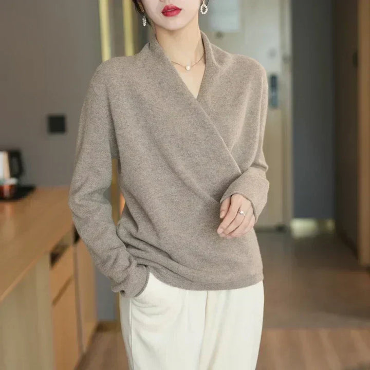 Full-length shot of a women's wrap neck knit top, paired with jeans for a chic, casual summer outfit.