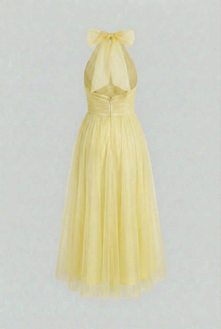 Bright yellow A-line halter neck midi dress for women, versatile for parties, beach or elegant summer outfits.