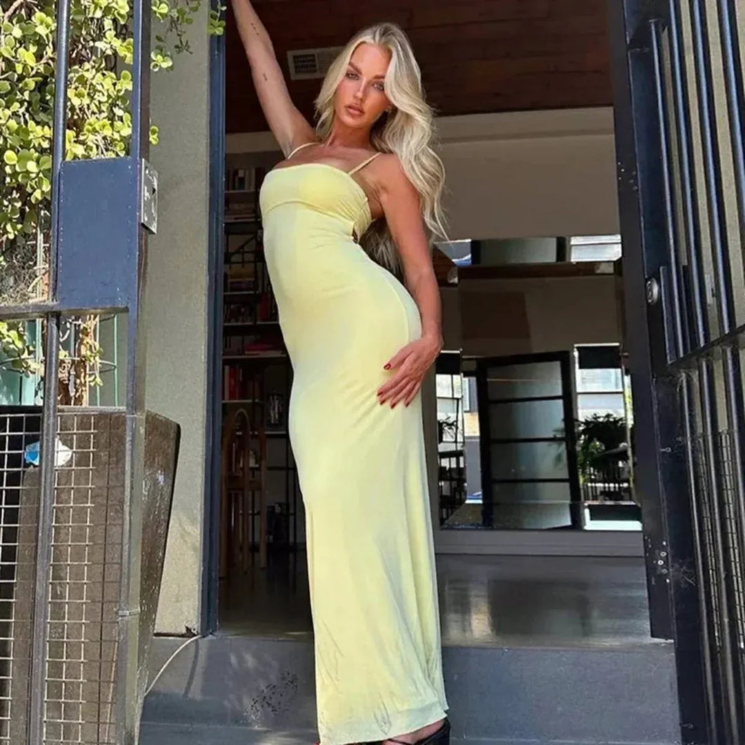 Chic yellow sleeveless maxi dress, bodycon fit with an elegant backless design for evening wear.