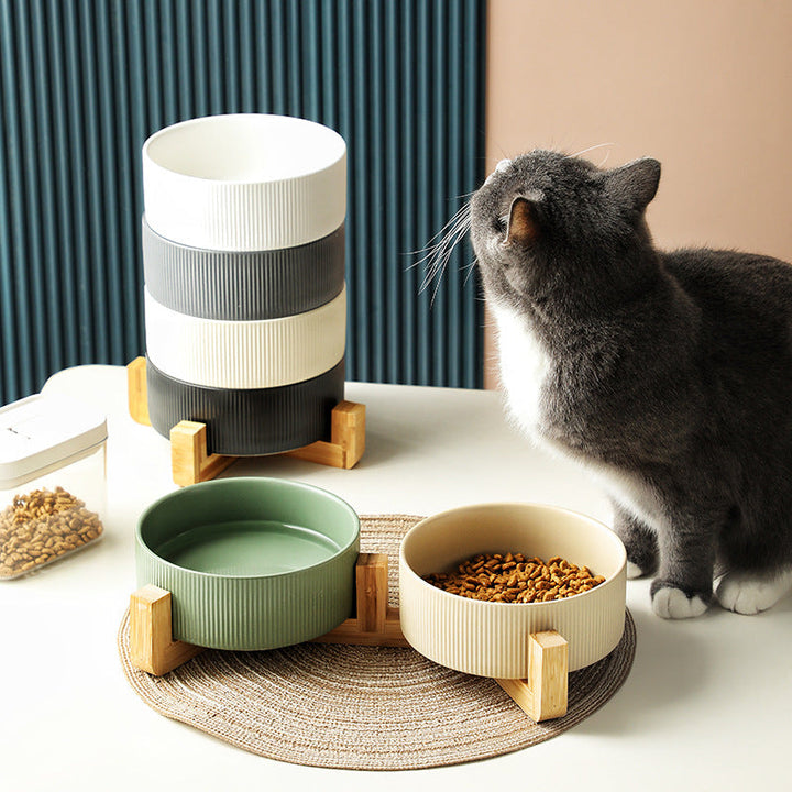 Elevated ceramic pet bowls on a stylish wooden stand for dog and cat feeding.